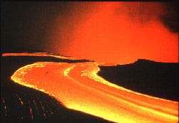 Photo shows a flow of orange hot lava.