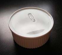 Photo of a paper clip floating on the surface of water in a bowl.