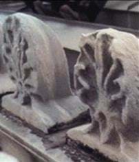 A picture of two pieces of building ornaments. Both pieces show deterioration, the effect of acid rain.