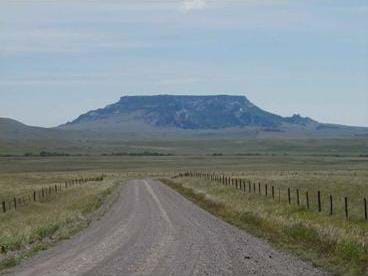 A photograph of Square Butte, found in Montana. It is a national natural landmark, and an excellent example of a naturally butte - formed from magmatic rock.