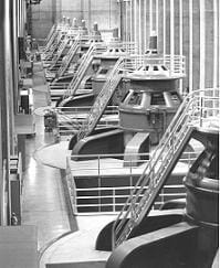 Row of metal turbines with ladders.