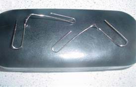 Photo shows two bent paperclips with the two curved ends pulled away from each other at right angles. 