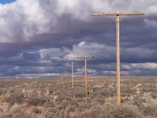 A photograph of telephone lines stretching across the prairie.