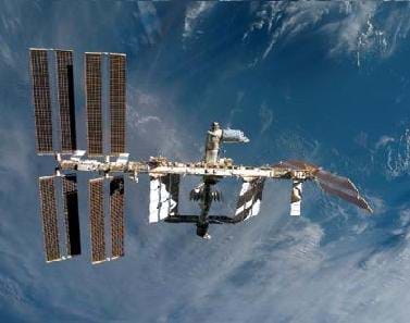 A picture of the International Space Station orbiting Earth. The Earth can be seen in the background.