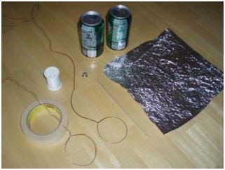 Photograph of the materials needed for this activity. Shown is a square of aluminum foil, two copper wires, masking tape, spool of thread and two aluminum cans.
