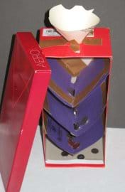 Photo shows a shoe box standing up vertically, with a funnel opening cut through the top and cardboard levels taped inside the box with variously-sized holes, and coins caught at every level.