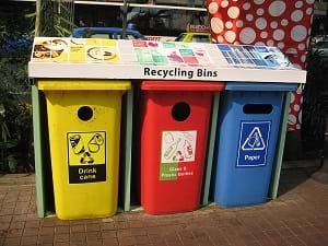A photograph shows three recycling bins for drink cans, glass & plastic bottles, and paper.