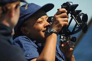 A Coast Guard Academy Cadet onboard the USCGC Eagle uses a sextant to take a sun line.