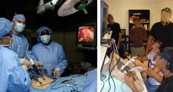 Two photos: (left) Three gowned and gloved people working over a human torso with a few medical devices puncturing it and many cables nearby, all watching a monitor showing tool movement and organs inside the abdomen. (right) Two students watch a monitor as they use their hands to control a remote camera and tools working behind a framed panel.