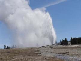 A geyser shoots highly-pressurized water from the ground to a height of several meters.