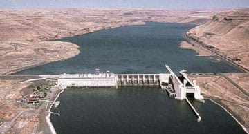 Aerial photo shows a dam across a river.