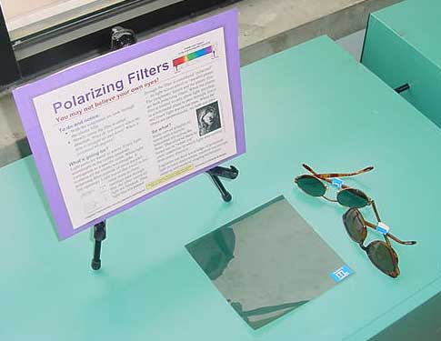 Photograph of sunglasses and a sheet of plastic.