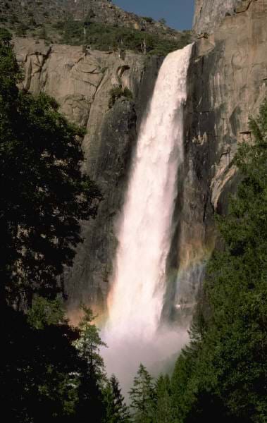 A photograph shows water dropping from a very high waterfall.