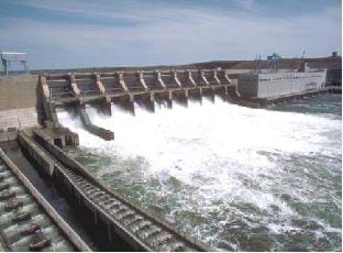 A photograph shows the gates of a hydropower dam