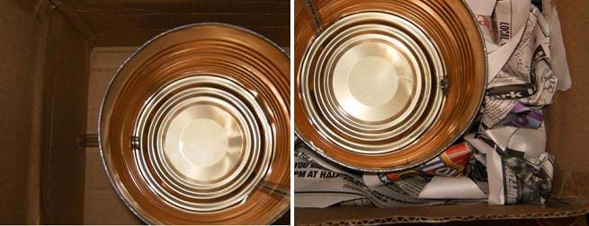 Two photos: (left) Looking down into a cardboard box at a metal coffee can at the bottom with plastic tubing visible inside and outside the container via holes in the container and box walls, (right) Looking down into a cardboard box at a metal coffee can at the bottom with crumpled newspaper stuffed into the space between the can and the box walls.