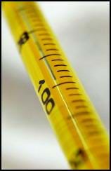 Close-up photo shows a yellow thermometer with mercury showing close to 100 degrees.