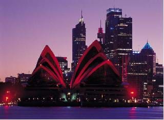 Photograph of an Olympic city, Sydney, with a view of the Opera House and skyscrapers in the background.