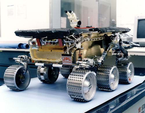 Photo shows a six-wheeled robot sitting on a tabletop.