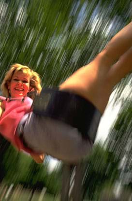 Photo shows a girl swinging.