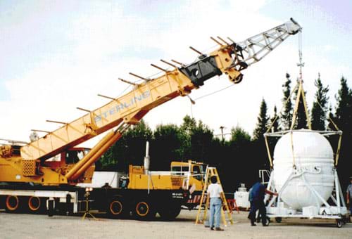 Photograph of a large crane lifting a heavy object.