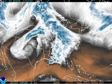 A satellite image shows the curling clouds of a weather system hovering over the continental U.S.