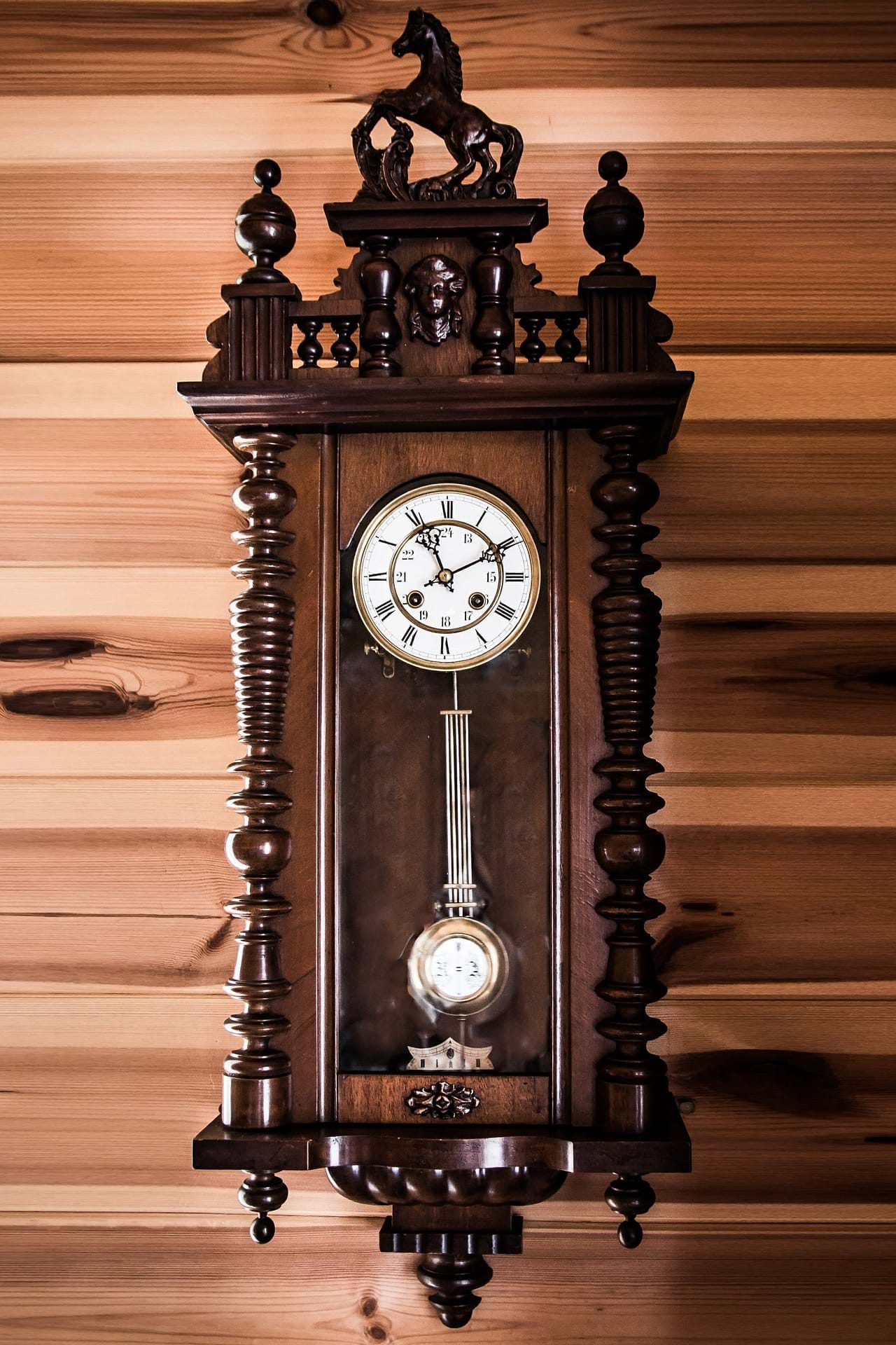 A wooden clock with a pendulum