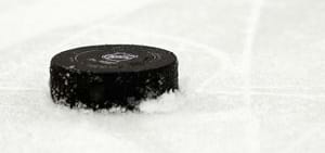 A hockey puck on the ice.