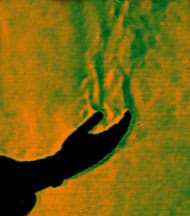 An image shows the silhouette of an open-palmed human hand with waves of green and orange above it, showing a flow of heat into the air from the hand.