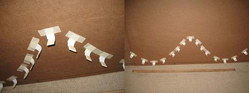 A wide composite photograph shows a horizontal cardboard backing being prepared for the roller coaster rail by the placement of 20 or more one-inch vinyl corner bead pieces taped to the cardboard along the hills and valleys of the roller coaster path. They serve as L-bracket supports for the pipe insulation rail, which is added next.
