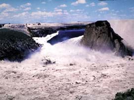 Photo shows water gushing through a break in the wall of a dam. Photo shows water gushing through a break in the wall of a dam.