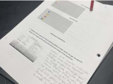 A photo of a student filling out a lab report.