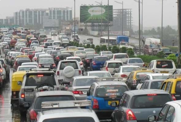 A photo of an urban highway traffic jam with cars, trucks, and buses.