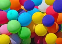 Photo shows more than 20 balloons of various colors.