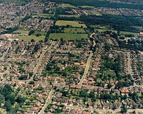 A photo of densely packed homes and the roads leading between them.