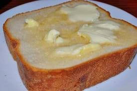 A close up of a piece of bread with butter.