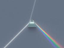 A beam of white light passes through a prism that separates it into light beams of individual colors.