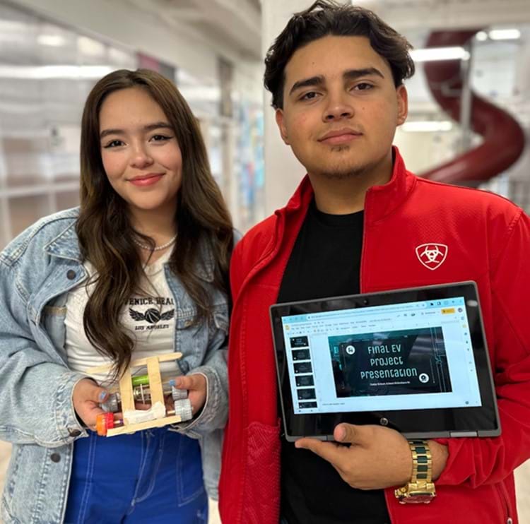 A team of two students who designed a model electric vehicle. 