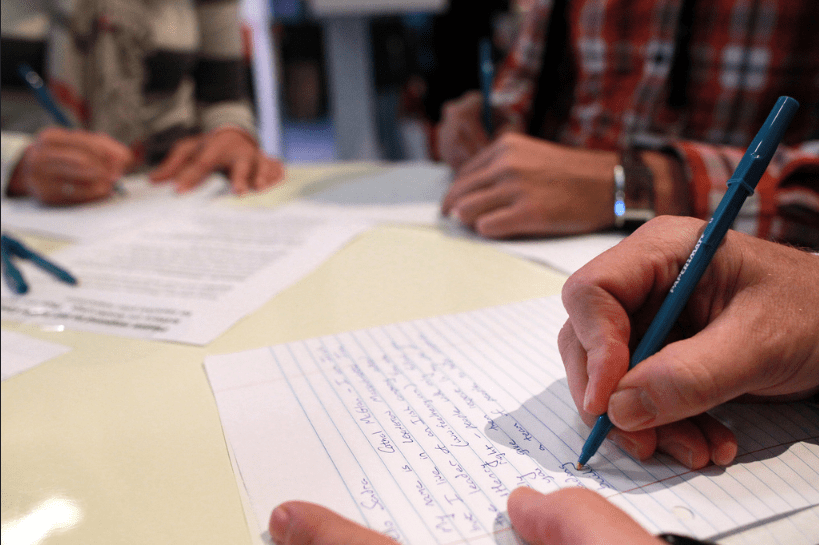 Up close photograph of hand writing letter.