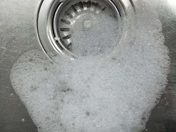 Soap suds forming in a sink.