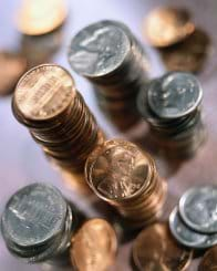 Photo shows stacks of coins. 