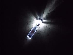 A glowing flashlight turned on in the dark.