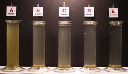 A photograph shows vials of water lined up in a row, from very cloudy water to very clear water. The vials are labeled A through E, with A being high turbidity and E being low turbidity. Turbidity is measured by NTU (Nephelometric Turbidity Units). The higher the NTU, the cloudier the water.