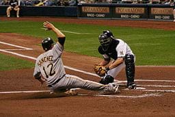A baseball player sliding into home plate.