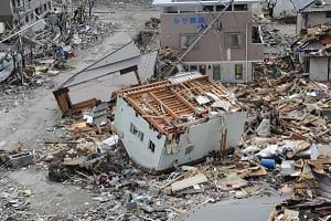 An upside down damaged house among debris following a 9.0 magnitude earthquake in Ofunato, Japan.