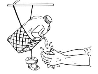 Line drawing shows a tipping plastic jug of water hanging in a net from a support above it, with a pair of hands washing under water dripping from a hole in the curved jug handle.