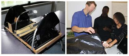 Two photos: (left) A 1 x 2-ft wooden base on a tabletop, filled with sausage-shaped tubes and three arching ribs, the ends covered in black plastic. (right) A teacher and two students stand at a table where one teen is guiding something that is behind an arched shape covered in black plastic.