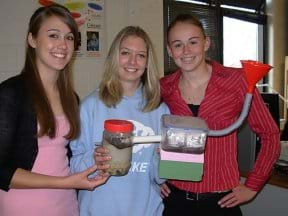 A high school student team builds a septic tank system with a slow sand filter.