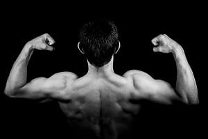 A young man showing his back muscles and biceps.