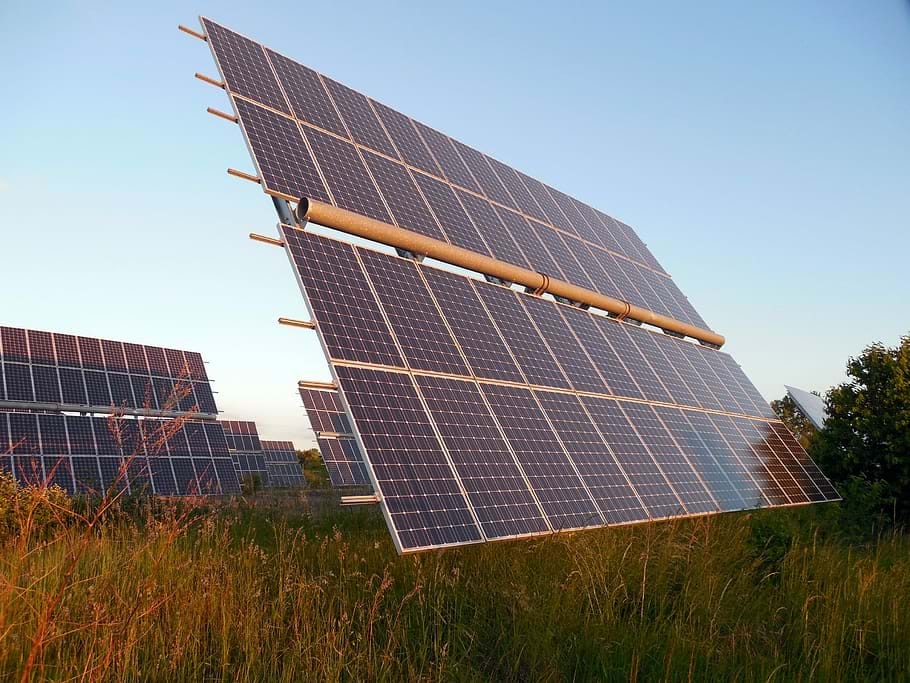 A photograph of photovoltaic (PV) panels mounted in a field. PV panels convert sunlight into electricity directly using a physical property called the photoelectric effect.