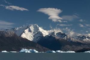 A photograph shows a huge snow-capped mountain with water in the foreground—the Andean range over the Santa Cruz province and Lake Argentino.